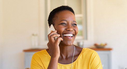 Woman smiling while talking on phone