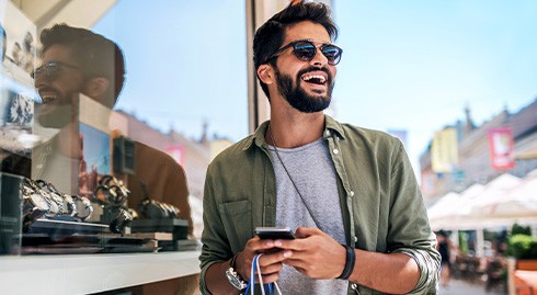 Man smiling while shopping outside