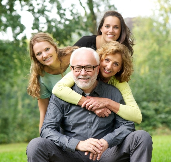 Family of four smiling outdoors