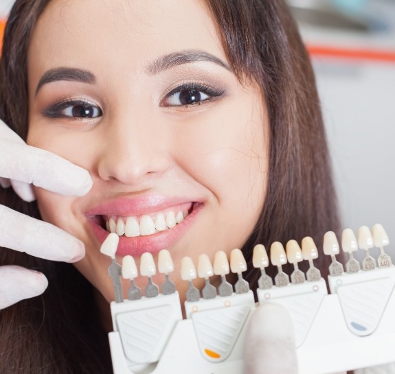 Young woman getting dental veneers from her cosmetic dentist in Raleigh