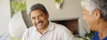 Smiling man sitting on living room couch