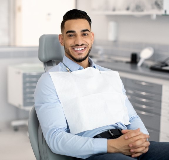 Smiling man sitting in dental chair