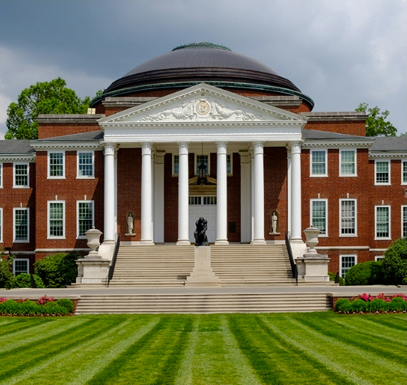 Front of red brick academic building with white pillars