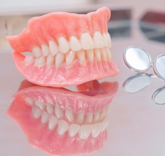 Set of full dentures on a metal tray