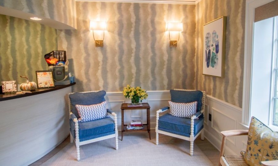 Two blue and white chairs next to reception desk