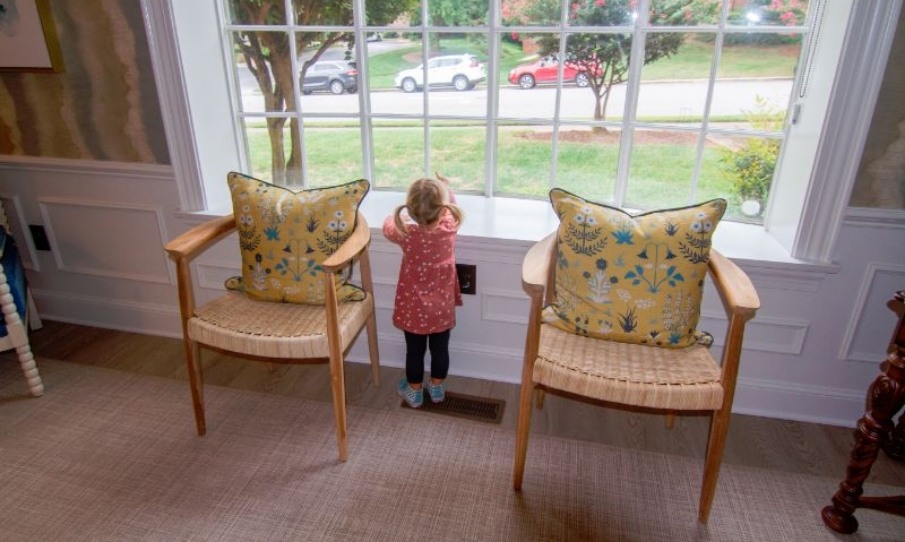 Little girl looking out window of reception area