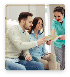 Dental team member showing a pamphlet to two patients