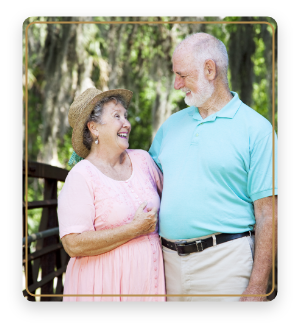 Senior man and woman holding each other outdoors