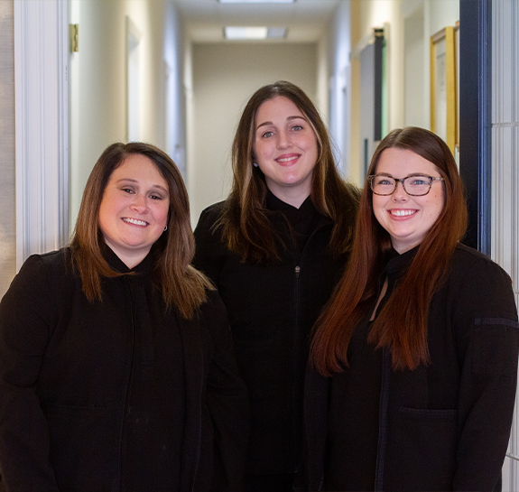 Three smiling dental team members in Raleigh at Dalton Hunt Dentistry