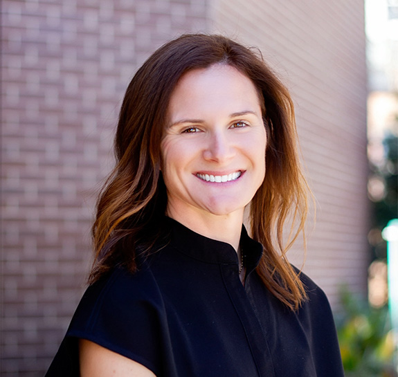 Family of four smiling outdoors